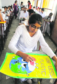 Students take part in a painting competition at Shashtri Model School, Phase-1, in Mohali on Wednesday.