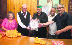 Municipal Council president presents an award to Colleen and Hugh Gantzer in Mussoorie on Wednesday.