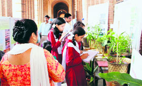 School students take  down notes at an exhibition put up at the Forest Rersearch Institute in Dehradun on Wednesday on on World Environment Day.