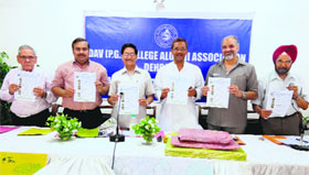 Members of the DAV College Alumni Association release a souvenir at a function in Dehradun on Wednesday.
