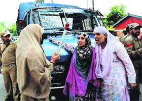 A policewoman tries to restrain protesting members of the All National Youth Corps in Srinagar on Wednesday