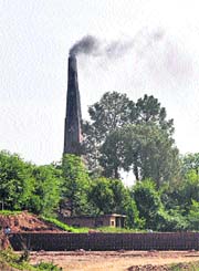 Thick smoke billows out from a brick kiln in Rajouri district.
