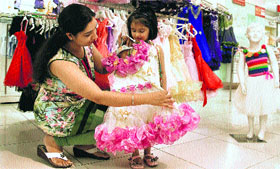 A woman chooses a dress for her daughter at a mall in Jalandhar.