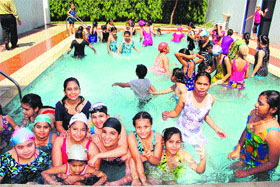 students of MGN Public Urban Estate enjoy the pool party during a summer camp.