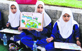 Schoolchildren take part in a painting competition on World Environment Day at Badamwari Garden in Srinagar on Wednesday.