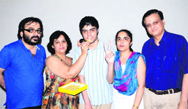 State NEET topper Agam Bhandari being offered sweets by his mother in Ludhiana on Wednesday.