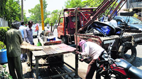 Staff of the MC tehbazari wing remove temporary encroachments on the roadside in a market in Ludhiana on Wednesday.