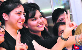 Anikpreet Kaur (left) and Neha Kumari, who secured the first and second position, respectively, in BBA-II in PU, in a jubilant mood in Ludhiana.