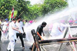 Punjab Youth Congress activists brave water canons during a protest in Chandigarh on Wednesday. They were seeking the arrest of the killers of Patti Youth Congress leader Sukhraj Singh.