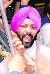 State Youth Congress chief Vikramjit Chaudhary being taken into custody.