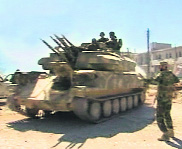 A video grab of soldiers standing near a tank in Qusair after the Syrian army took control of the city from rebel fighters on Wednesday. 