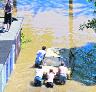 People push a car out of a garage flooded by the Elbe river in Dresden, Germany, on Wednesday.