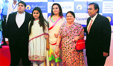 Reliance Industries chairman Mukesh Ambani (R) poses with his son Akash, daughter Isha (2nd L), wife Nita (C) and mother Kokilaben before addressing the companys AGM in Mumbai on Thursday. RIL plans to invest Rs 1.5 trillion (US $26.4 billion) in its businesses over three years, Ambani told shareholders.