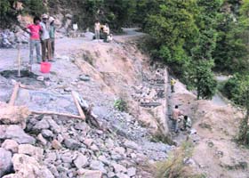 Limestones and sleet being used for the construction of sidewalls of the road and tractor trolleys being filled with excavated stones by contractors on the Mackinnon Cart Road to be used elsewhere