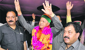 Chief Minister Virbhadra Singh raises hands to greet the crowd at Janjheli on Thursday.