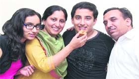 Angad Mahajan, who stood second in the NEET exam in the district, with his family in Jalandhar on Thursday