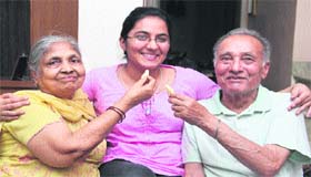 Rasika, who stood third in the NEET exam in the district, with her family in Jalandhar on Thursday