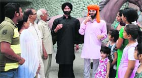 Chander Shekher Prabhakar with the wax statues of Bollywood stars Sunny Deol and Dharmendra in Ludhiana