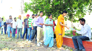 Students stand in a long queue to buy admission form at Government Mohindra College in Patiala on Thursday. 