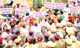 Mohali MLA Balbir Sidhu leads a protest against the Education Minister outside his residence in Kansal on Thursday. 