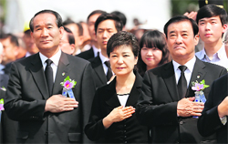 South Korean President Park Geun-Hye (C) salutes the national flag during a ceremony marking Korean Memorial Day in Seoul on Thursday. 