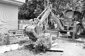 A JCB machine removes encroachments from a park at Sector 71 in Mohali on Friday.