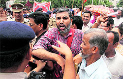 Leaders of the Left parties hold a protest against the proposed Coca Cola plant in Dehradun on Friday