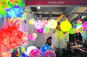 A worker decorates a stall at the Mega Mart held at the sports complex in Shimla on Friday.