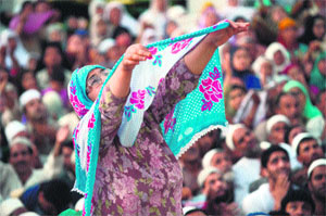 Muslims pray as an unseen custodian displays a holy relic, believed to be a hair from the Prophet Muhammad's beard, at the Hazratbal shrine in Srinagar on Friday during Meraj-ul-Alam (Ascension to Heaven).