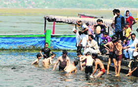 Children beat the heat at Dal Lake in Srinagar on Friday.