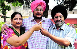 Neha Jindal; and Puneet Singh of Arya College celebrate with their parents in Ludhiana on Friday