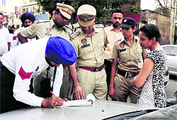 A resident being challaned at Ghumar Mandi in Ludhiana on Thursday