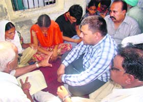Rajesh Bagha, Chairman, State Commission for Scheduled Castes, with the family members of the deceased sarpanch of Chhuchhewal village in Nawanshahr on Friday