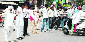 Members of the management and followers of the Seventh Day Adventise Church block traffic on the GT Road in Amritsar on Saturday. 
