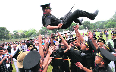 Gentlemen Cadets toss up one of their batchmates after the passing-out parade at the Indian Military Academy in Dehradun on Saturday. 