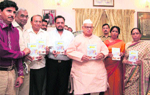 Governor Aziz Qureshi releases a book during a function at Raj Bhawan in Dehradun.