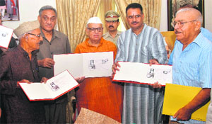Governor Aziz Qureshi and Chief Minister Vijay Bahuguna release a special postal cover on Abbas Tyabji, a prominent freedom fighter, in Dehradun on Saturday. 
