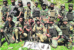A team of Rashtriya Rifles and the police with arms seized by them from Berna Keshwan in Kishtwar on Saturday