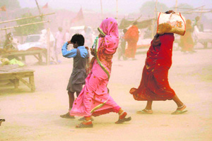 People run for cover during a dust storm in Allahabad on Saturday.