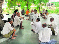 Kheri panchayat members hold a meeting under a tree in Bishnah tehsil in Jammu on Sunday.