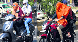 Two-wheeler riders cover their faces to save themselves from scorching heat in Jalandhar on Sunday