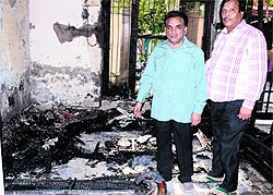 A man points towards the items that were gutted in a house in Deol Nagar, Jalandhar, on Sunday