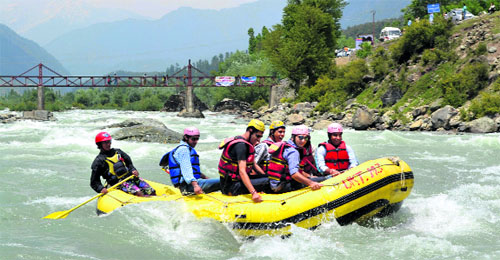 Tourists enjoy rafting in the Lidder river at Pahalgam in Anantnag district.