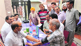 Dr Surinder Gupta, secretary, NIMA, Ludhiana, checks a patient during the free medical camp in Ludhiana.