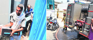Workers remove documents from the room where the fire broke out; and (right) a fire engine parked outside Union Information and Broadcasting Minister Manish Tewaris residence in Ludhiana on Sunday.