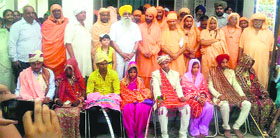 Couples during a mass marriage ceremony at Brahampur village near Mandi Ahmedgarh on Sunday.