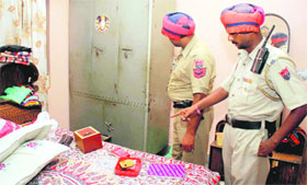 Policemen inspect a house in Haibowal where swindlers struck on Saturday night.