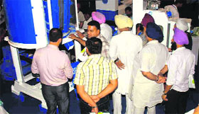 Rice millers inspect machinery on the second day of the rice expo at Sahnewal. 