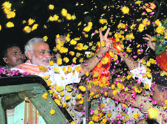 Gujarat Chief Minister Narendra Modi being welcomed by his supporters upon his arrival at Ahmedabad airport on Sunday.