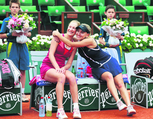Ekaterina Makarova (L) and Elena Vesnina of Russia celebrate after defeating Sara Errani and Roberta Vinci in their women's doubles title at the Roland Garros stadium in Paris on Sunday.
